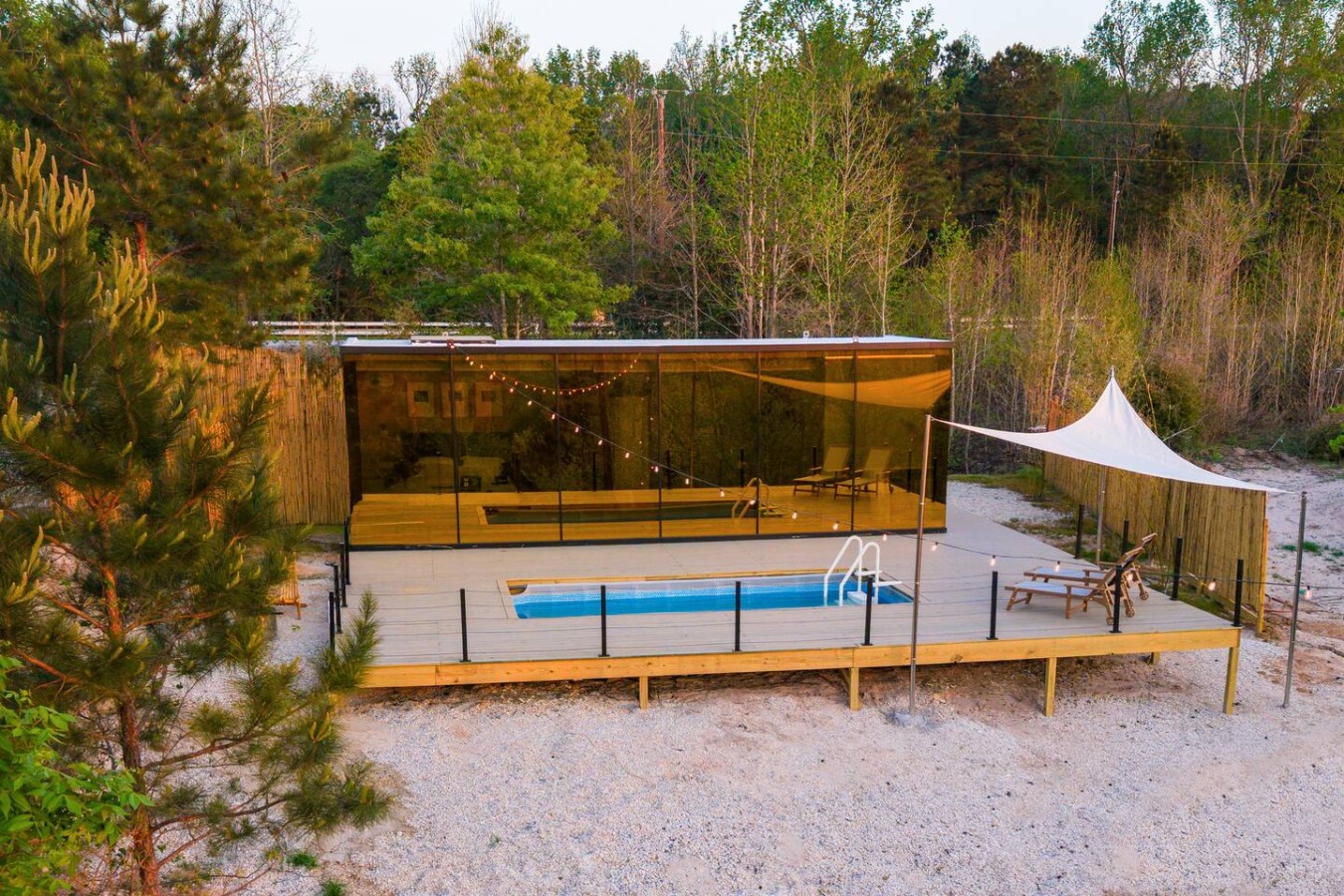 Aerial view of Mirror House — mirrored facade reflecting forest